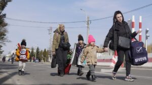 Family walking with luggage on a street.
