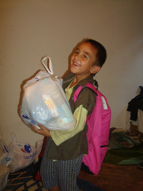 A boy holding a bag of food in his hands.