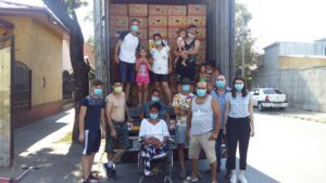 A group of people standing around a truck.