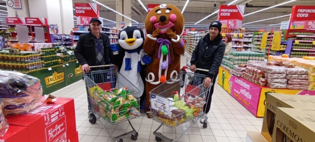 Three men are standing in a store with shopping carts.