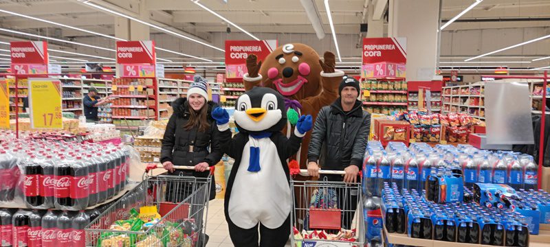 A group of people standing in a store with shopping carts.