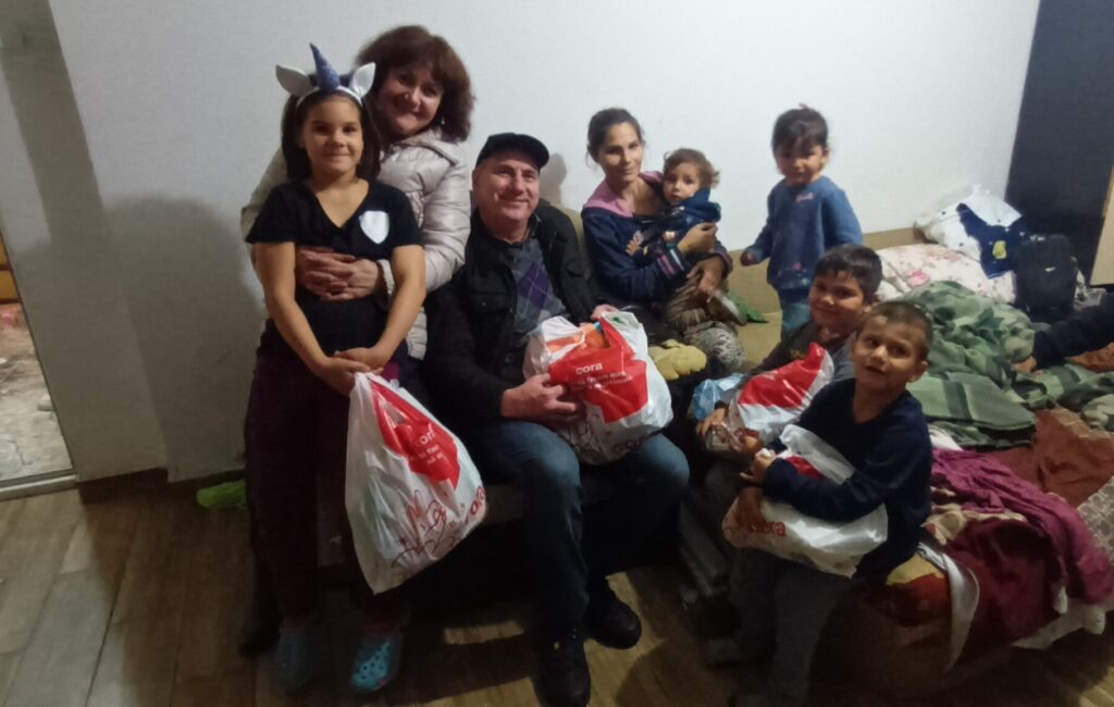 A group of people holding bags and posing for the camera.