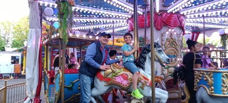 A man and boy on a merry go round.