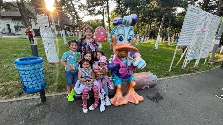 A group of children posing with an inflatable duck.