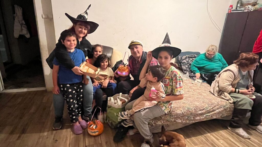 A group of people in costumes sitting on the floor.