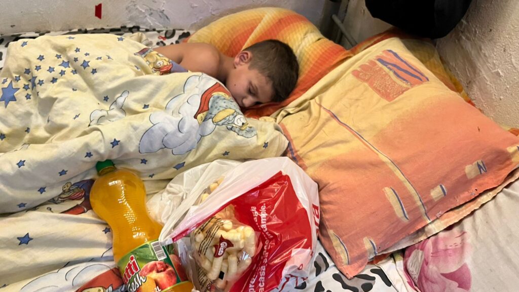 A child sleeping on the bed with food