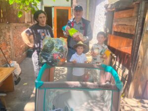Family standing by playpen in sunlit courtyard
