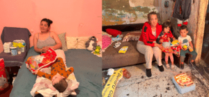 Mother and children receiving aid in a home.