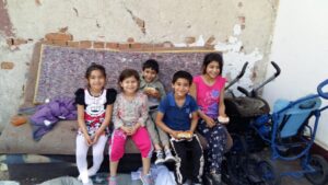 Five children sitting on couch eating sandwiches